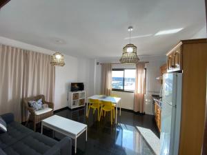 a kitchen and living room with a couch and a table at Los Zifios in La Restinga +13 photos