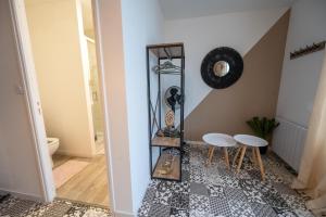 a hallway with two stools and a mirror at NG SuiteHome - Lanester Lorient - Balnéo - Netflix - Wifi in Lanester