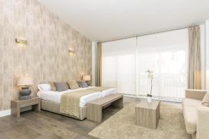 a bedroom with a bed and a large window at Valencia Luxury - Central Market in Valencia