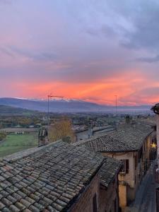 a view from the roof of an old town at sunset at Gabri's Home in Spello