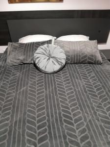 a bed with a gray comforter and two pillows at Quintinha dos Queiroses in Vila Boa de Quires +45 photos