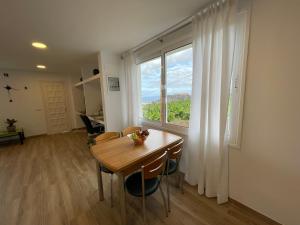 a dining room with a table and a large window at Parque La Guina in La Orotava