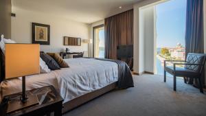 a hotel room with a bed and a balcony at Bellevue Superior City Hotel in Šibenik +69 photos