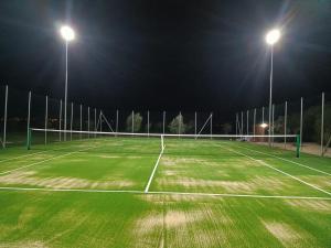 a tennis court at night with two lights at B&B Giardinello in Comiso