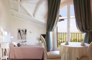 a bedroom with two beds and a large window at Locanda San Giorgio in Neviglie