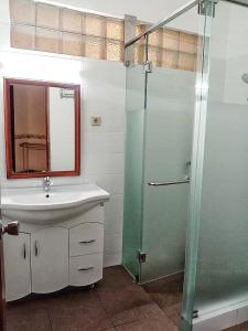 a bathroom with a sink and a shower at Kulem Cisitu in Bandung