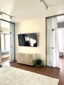 a living room with a flat screen tv on a wall at Logvinenko apartment in Bishkek +23 photos