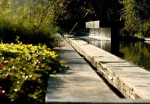 a walkway next to a pond with a fountain at Borgo San Gregorio in Sorbo Serpico