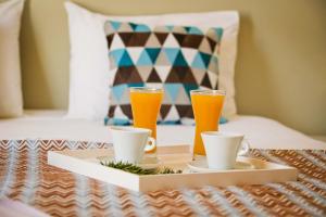 a tray with two drinks and two cups on a table at Nammos Sunset in Psérimos