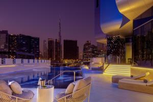 a pool on the roof of a building with a city skyline at Hyde Hotel Dubai in Dubai