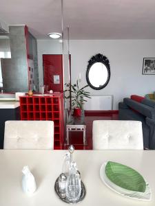 a kitchen and living room with a table with a plate at Metro Suites in Tirana
