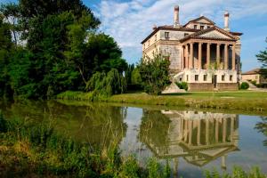 an old building next to a body of water at Isola Di Caprera in Mira