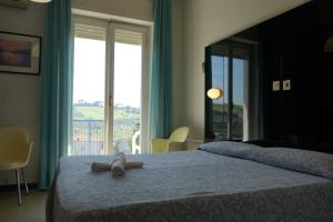Postel nebo postele na pokoji v ubytování Grand Hotel Excelsior