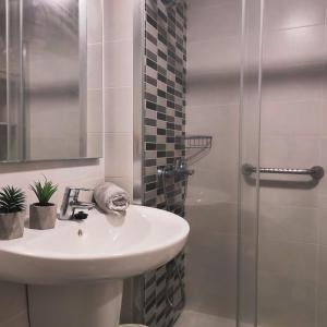 a bathroom with a sink and a shower at Beach Apartment 9 in Patalavaca +16 photos