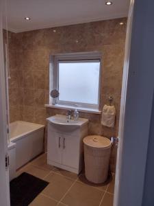 baño con lavabo, bañera y ventana en 33 Valentia place en Newcastle