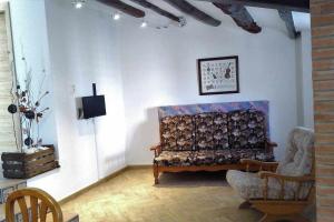 a living room with a couch and a chair at Casa de pueblo con encanto in Tarragona
