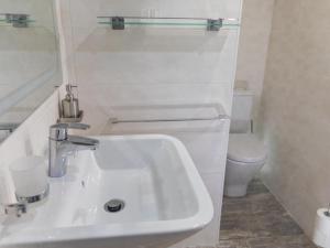 a white bathroom with a sink and a toilet at SUNSET RUBY ,1 Bedroom, SWIMMING POOL in Caleta De Fuste