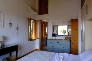 a bedroom with two beds and a sink in it at Villa Paparouna in Magaziá +51 photos