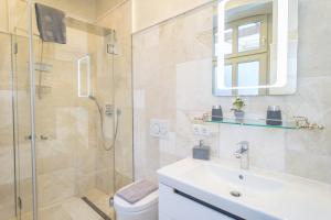 a bathroom with a shower and a sink and a toilet at Rumpelstilzchen in Westerland