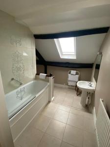 a bathroom with a bath tub and a sink at Guyers House Hotel and Restaurant in Corsham