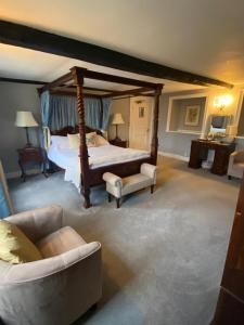 a large bedroom with a bed and a couch at Guyers House Hotel and Restaurant in Corsham