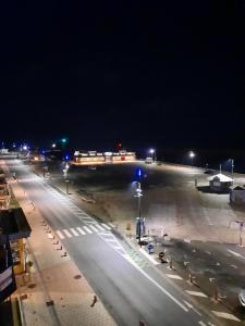 an empty street at night with lights on at Le pigeonnier 1 in Le Tréport