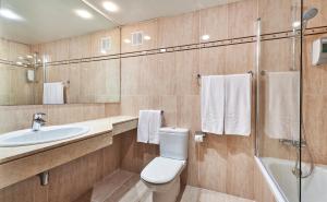 
a bathroom with a toilet, sink, and shower stall at Globales Cala'n Bosch in Cala en Bosc

