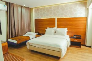 Voodi või voodid majutusasutuse Hotel Perce Neige toas