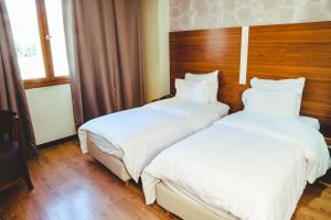 Voodi või voodid majutusasutuse Hotel Perce Neige toas