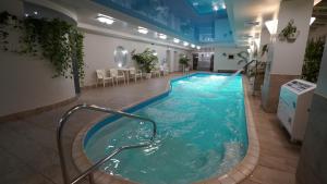 a large pool with a hot tub in a building at Mercury Hotel in Kharkiv