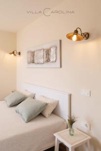 a bed with two pillows and a table in a room at Villa Carolina in Izola