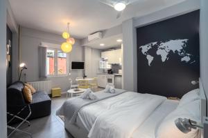 a bedroom with a map of the world on the wall at Petit Keramikos Studio - Historic Center in Athens