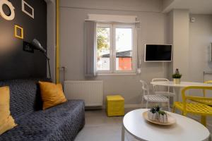 a living room with a couch and a table at Petit Keramikos Studio - Historic Center in Athens