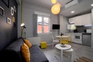 a living room with a couch and a table at Petit Keramikos Studio - Historic Center in Athens