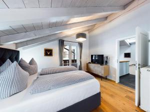 a bedroom with a large bed and a television at Hoamat 17 in Garmisch-Partenkirchen