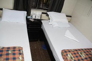 Ένα ή περισσότερα κρεβάτια σε δωμάτιο στο New Cosmos Hotel