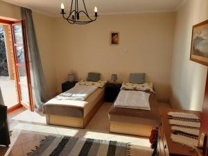 a bedroom with two beds and a chandelier at Holiday home Balatonalmadi - Balaton 17957 in Balatonalmádi +38 photos