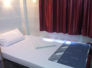 Ένα ή περισσότερα κρεβάτια σε δωμάτιο στο New Cosmos Hotel