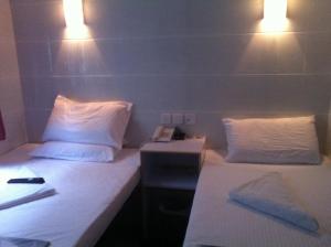 Ένα ή περισσότερα κρεβάτια σε δωμάτιο στο New Cosmos Hotel