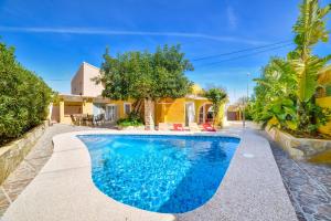a villa with a swimming pool and a house at Villa Alexandra - PlusHolidays in Calpe