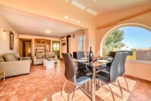an open living room with a table and chairs at Villa Alexandra - PlusHolidays in Calpe