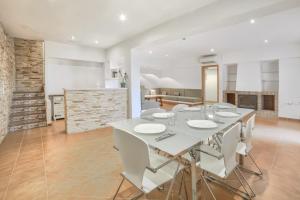 a dining room with a white table and white chairs at Villa Oasis - Plusholidays in Calpe
