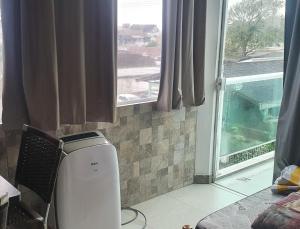 a room with a heater in front of a window at Suíte praia de leste in Pontal do Paraná