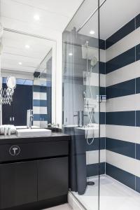 a bathroom with a sink and a shower at Hôtel Serge Blanco - Relais Thalasso & Spa in Hendaye