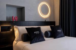 a bed with two black pillows on top of it at Agio Comfy Place in Civitanova Marche