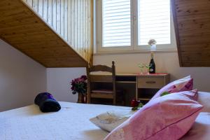 a bedroom with a bed and a desk and a window at Apartment Matic in Dubrovnik