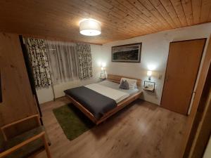 a bedroom with a large bed and a wooden ceiling at Apartment Alpenwelt in Neustift im Stubaital