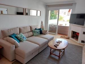 a living room with a couch and a fireplace at Carib Playa Marbella apartments in Marbella