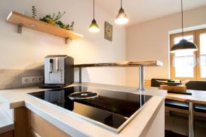 a kitchen with a sink and a stove top oven at Ferienwohnung Lorenz in Heufeld