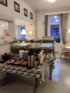 a kitchen with a table with food on it at Hotelli Merikotka in Kotka